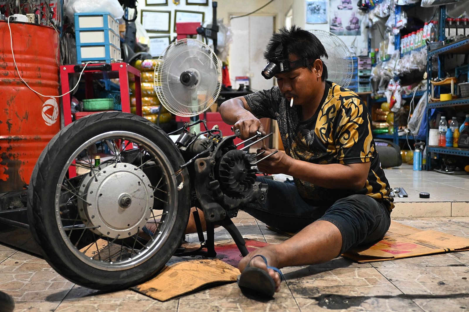 Spare parts shop owner at the counter handling wholesale stock